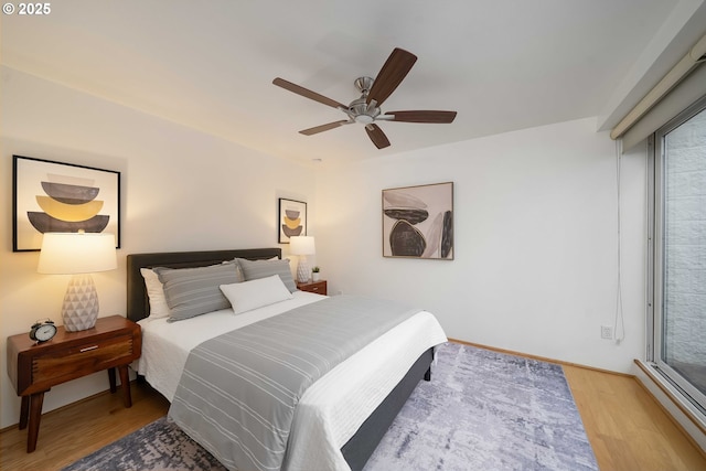 bedroom with ceiling fan and light hardwood / wood-style flooring