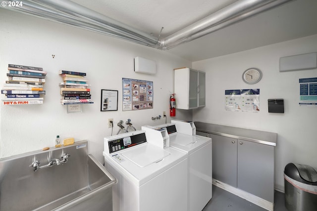 washroom with sink and washer and clothes dryer