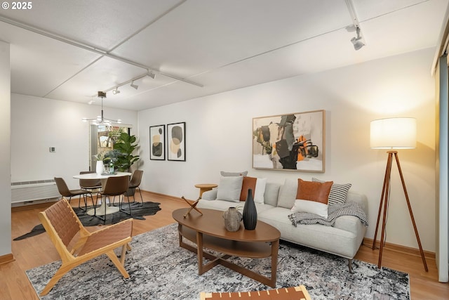 living room with wood-type flooring and rail lighting