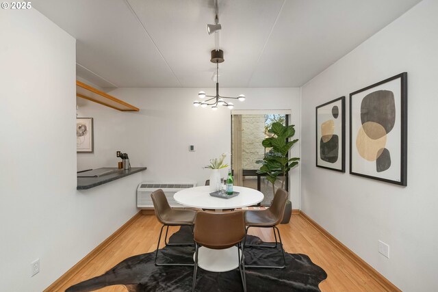 kitchen featuring white dishwasher, light hardwood / wood-style flooring, light brown cabinetry, electric range, and sink