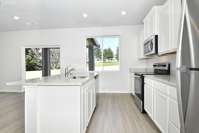 kitchen featuring sink, white cabinetry, light stone countertops, a kitchen island with sink, and stainless steel appliances