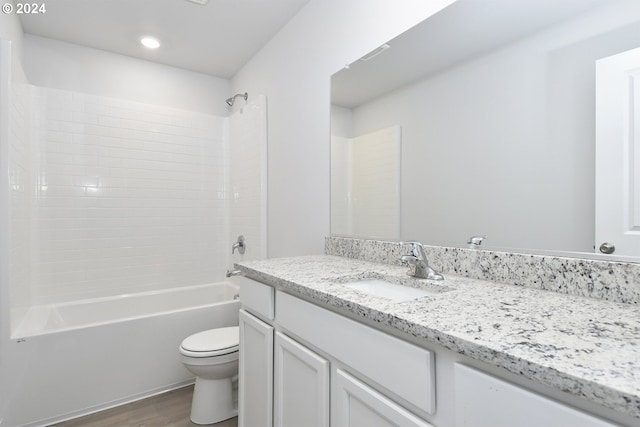 full bath featuring shower / washtub combination, vanity, toilet, and wood finished floors