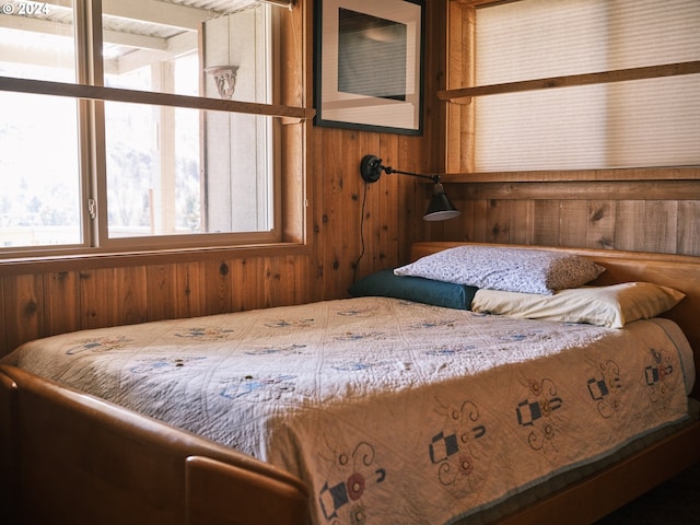 bedroom featuring wooden walls