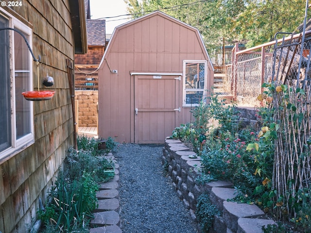 view of shed featuring fence