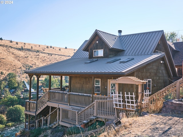 back of property with a wooden deck