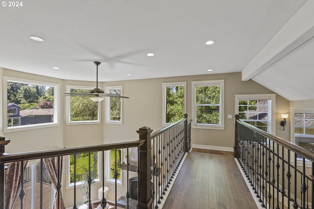 corridor with vaulted ceiling with beams and hardwood / wood-style flooring