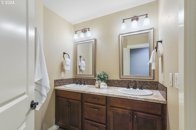 bathroom featuring vanity and backsplash