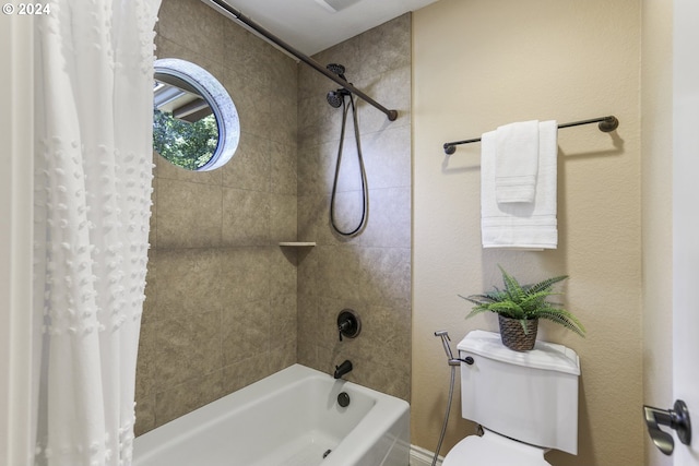 bathroom featuring shower / bath combination with curtain and toilet