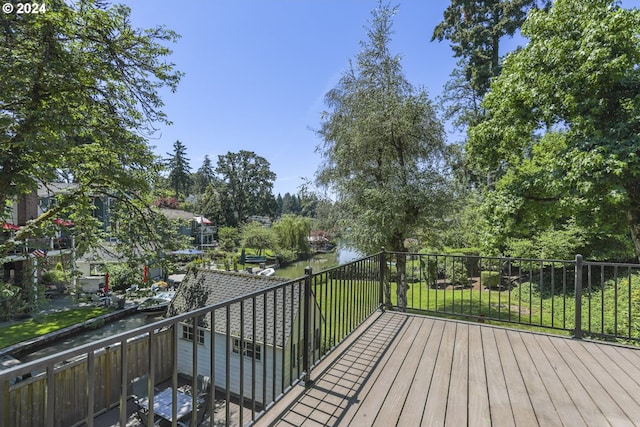 wooden deck featuring a water view