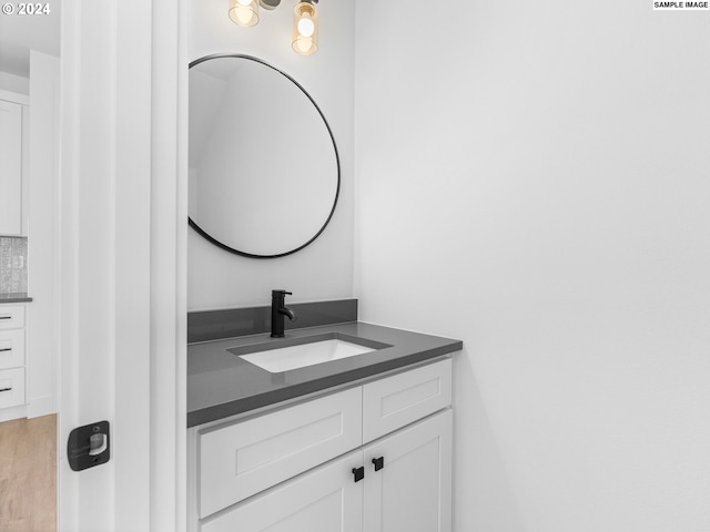bathroom with wood finished floors and vanity
