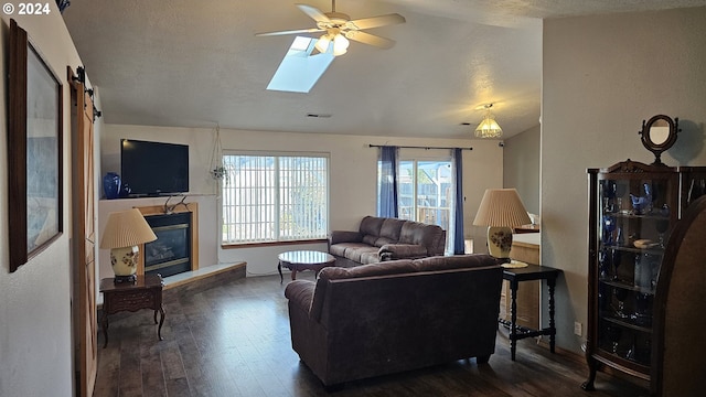 4072 Forsythia St, Springfield, OR 97478 - living area with a glass covered fireplace, wood finished floors, ceiling fan, lofted ceiling, and baseboards