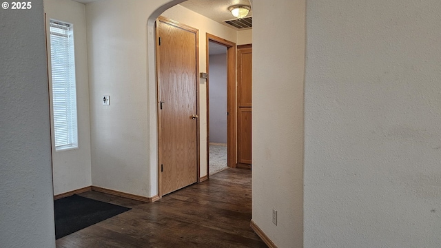 4072 Forsythia St, Springfield, OR 97478 - hall featuring arched walkways, dark wood finished floors, plenty of natural light, and a textured wall