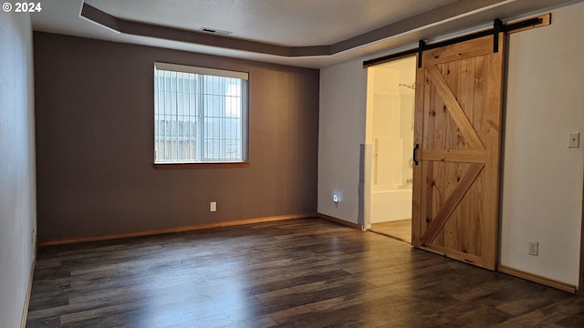 4072 Forsythia St, Springfield, OR 97478 - unfurnished bedroom with dark wood-style floors, a barn door, baseboards, and ensuite bathroom
