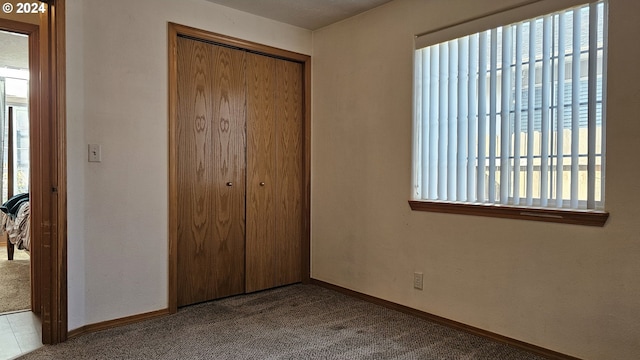 4072 Forsythia St, Springfield, OR 97478 - unfurnished bedroom with a closet, baseboards, and carpet
