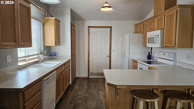 4072 Forsythia St, Springfield, OR 97478 - kitchen with white appliances, a sink, a peninsula, dark wood finished floors, and light countertops