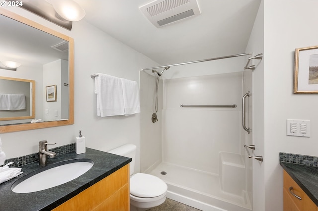 bathroom with walk in shower, vanity, and toilet