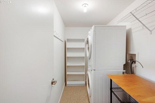 laundry area featuring stacked washer and clothes dryer