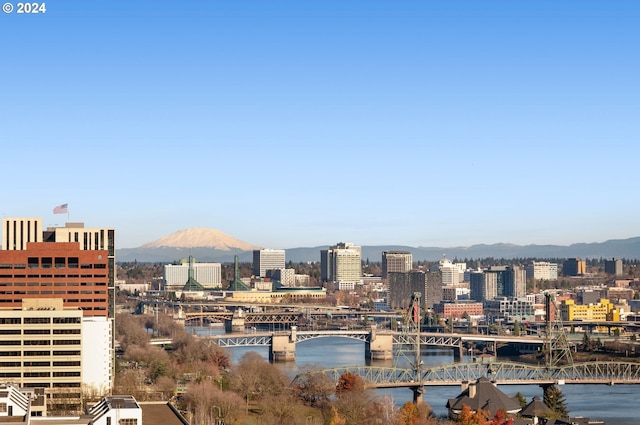 property's view of city featuring a water and mountain view