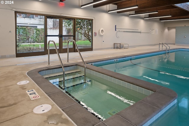 view of pool with french doors