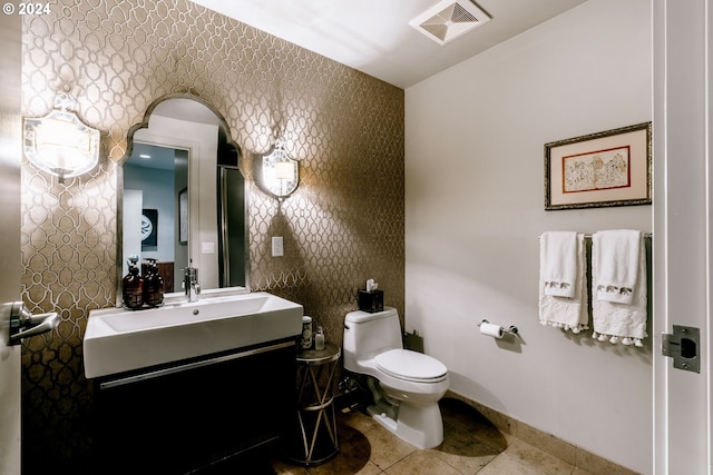 1930 S River Dr Unit W107, Portland, OR 97201 - half bathroom featuring visible vents, wallpapered walls, baseboards, toilet, and vanity