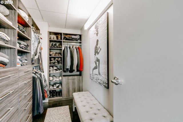 1930 S River Dr Unit W107, Portland, OR 97201 - walk in closet featuring a paneled ceiling and dark wood-style flooring