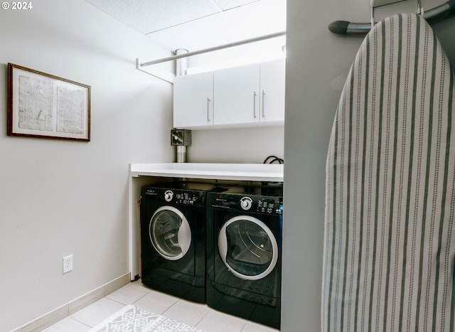 1930 S River Dr Unit W107, Portland, OR 97201 - clothes washing area featuring light tile patterned floors, baseboards, cabinet space, and washer and clothes dryer
