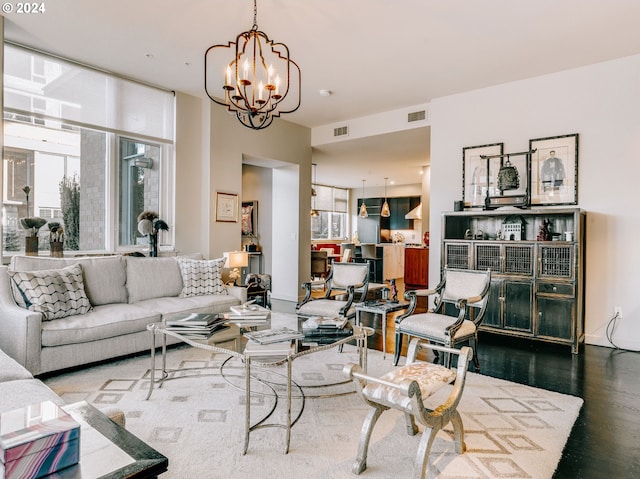 living room with dark wood-type flooring and a chandelier