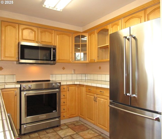 kitchen with tile countertops and stainless steel appliances