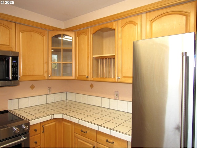 kitchen featuring stainless steel appliances and tile counters