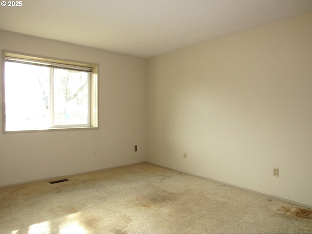 empty room with light colored carpet