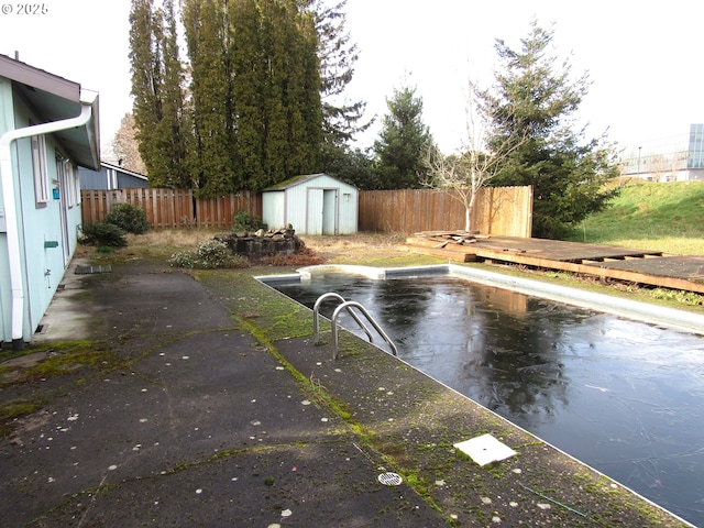 view of pool featuring a storage shed