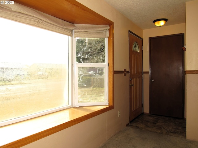 doorway with a textured ceiling