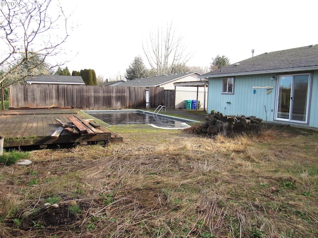 view of yard with a pool side deck