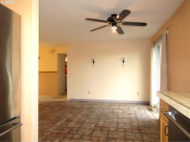 interior space with ceiling fan