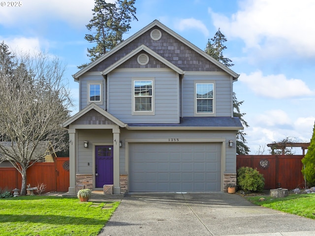 craftsman house with a garage and a front yard