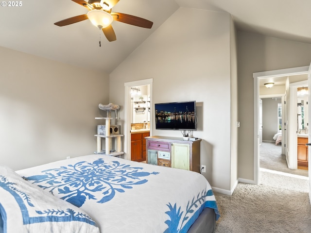 bedroom featuring a ceiling fan, light carpet, ensuite bath, high vaulted ceiling, and baseboards