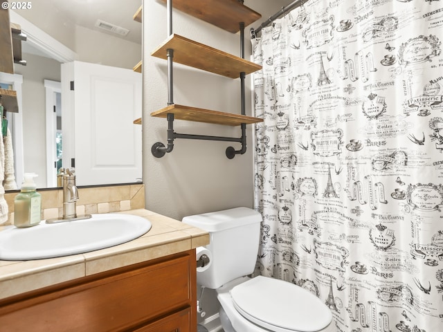 bathroom featuring toilet, visible vents, and vanity