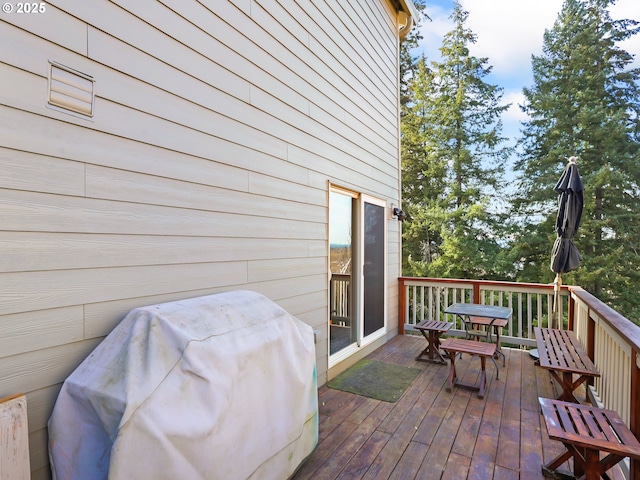 wooden terrace with a grill