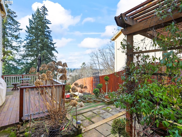 view of yard with fence, a wooden deck, and a pergola