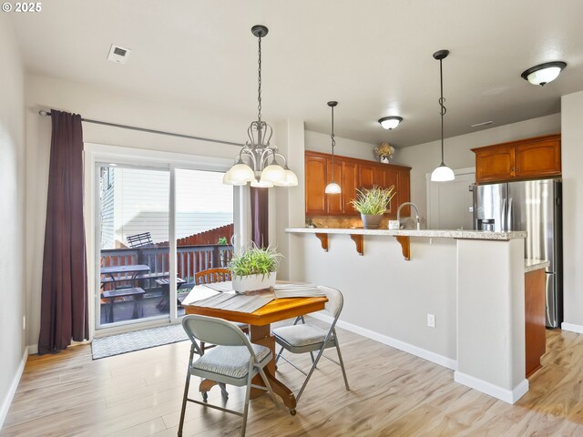 dining room with sink and light hardwood / wood-style floors