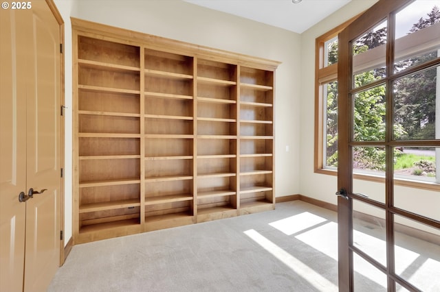 carpeted spare room featuring baseboards