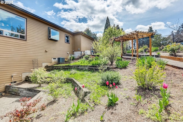 view of yard with fence, a pergola, and cooling unit