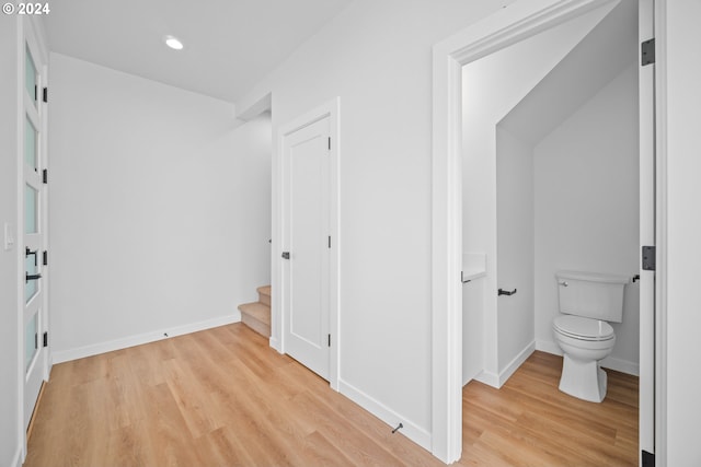 corridor with light hardwood / wood-style flooring