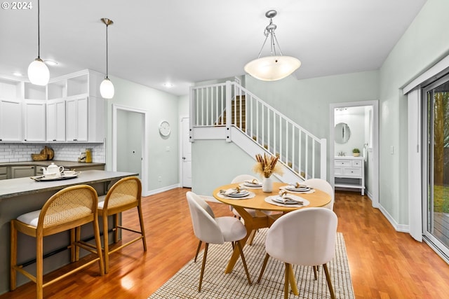 dining space with light hardwood / wood-style flooring