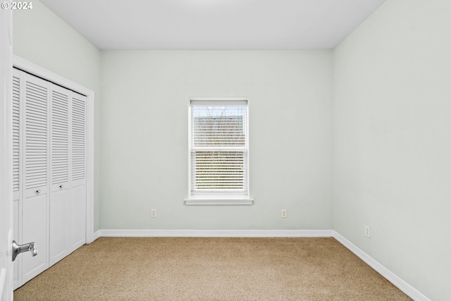 unfurnished bedroom with a closet and carpet