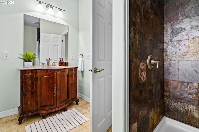 bathroom featuring vanity and tiled shower