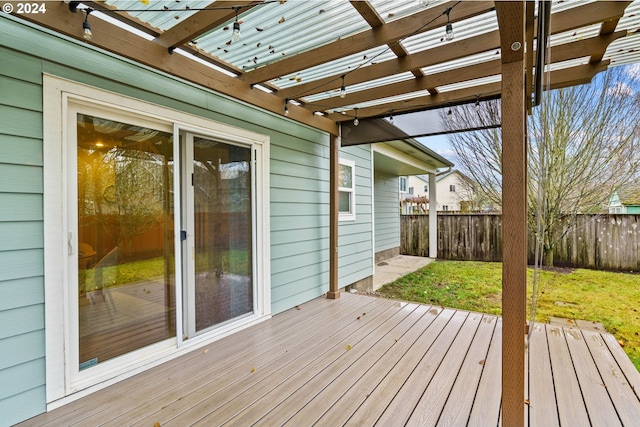 wooden deck featuring a pergola and a lawn