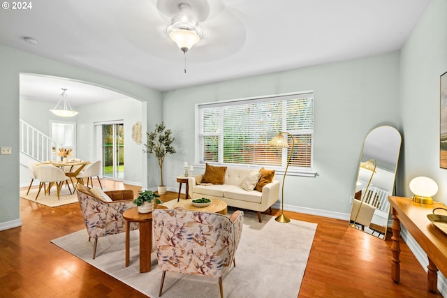 living room featuring ceiling fan and hardwood / wood-style flooring