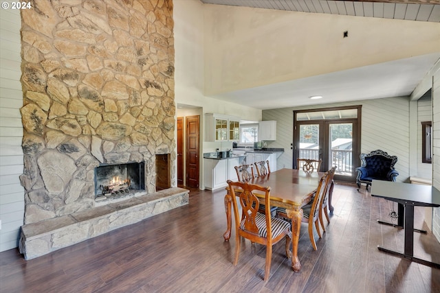 11635 NW Seavey Rd, Forest Grove, OR 97116 - dining space featuring a stone fireplace, high vaulted ceiling, dark wood-style flooring, and french doors