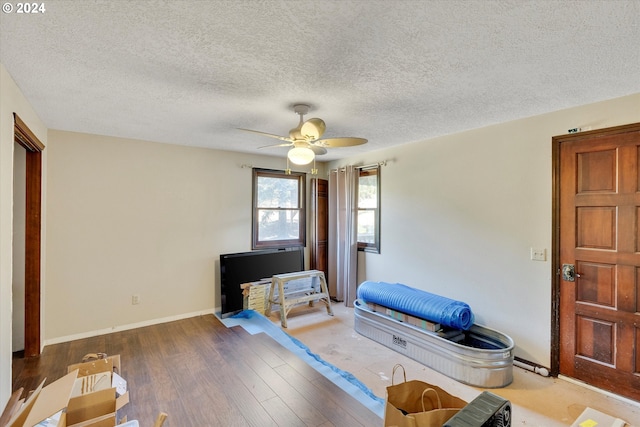 11635 NW Seavey Rd, Forest Grove, OR 97116 - bedroom featuring wood finished floors, a ceiling fan, baseboards, and a textured ceiling
